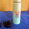 Kinnikinnick Trading Co. branded water bottle on blue surface.
